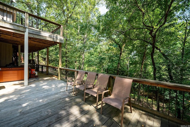 wooden deck with a hot tub