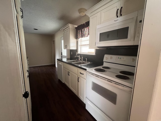 kitchen featuring a textured ceiling, white appliances, white cabinetry, and sink