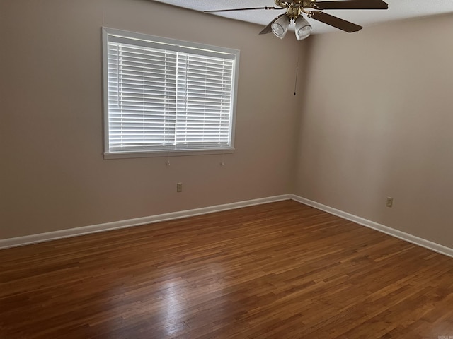 unfurnished room featuring ceiling fan and dark hardwood / wood-style flooring