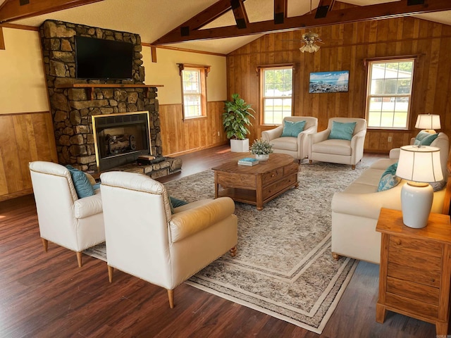 living room featuring vaulted ceiling with beams, ceiling fan, a fireplace, and dark hardwood / wood-style flooring