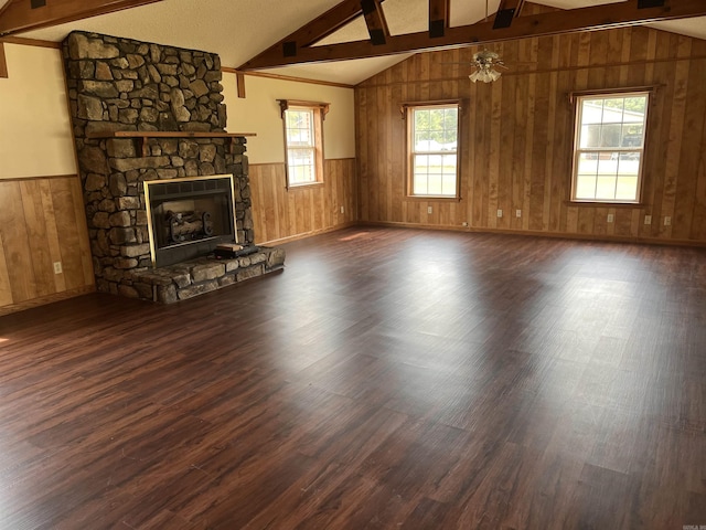 unfurnished living room featuring vaulted ceiling with beams, ceiling fan, a fireplace, and dark wood-type flooring