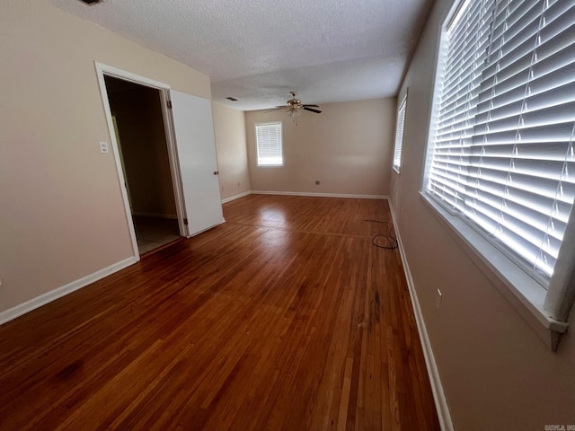 unfurnished room with a textured ceiling, hardwood / wood-style flooring, and ceiling fan