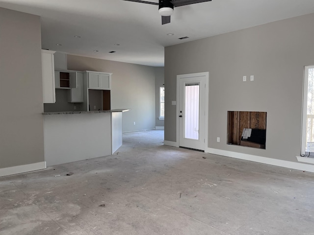 unfurnished living room with ceiling fan