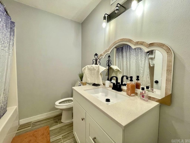 full bathroom with shower / bath combination with curtain, vanity, and toilet