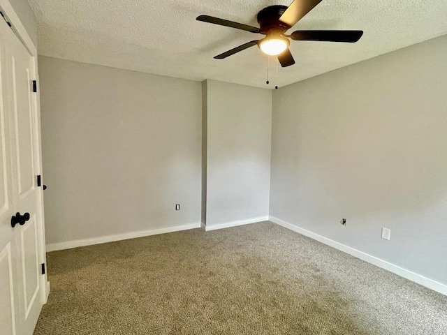 unfurnished room featuring ceiling fan, carpet floors, and a textured ceiling