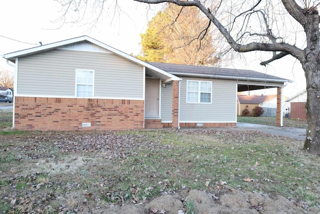 ranch-style house featuring a front yard and a carport