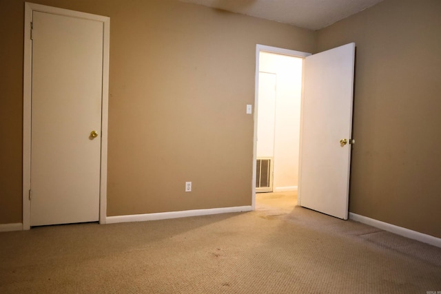 unfurnished room with light carpet