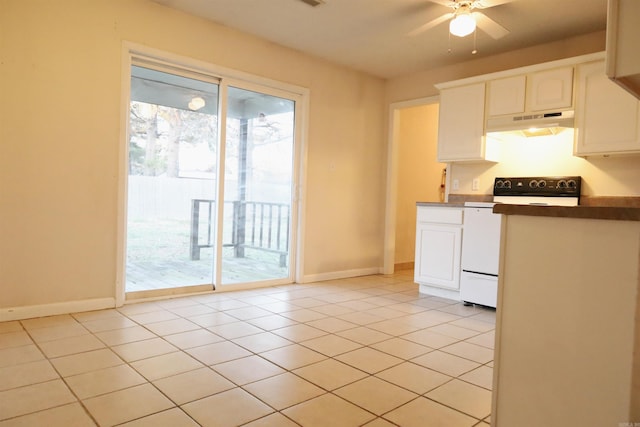 kitchen featuring ceiling fan, white cabinetry, light tile patterned floors, and range