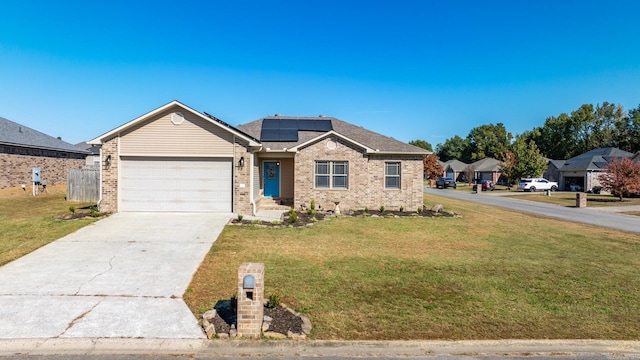 view of front facade with solar panels, a garage, and a front yard