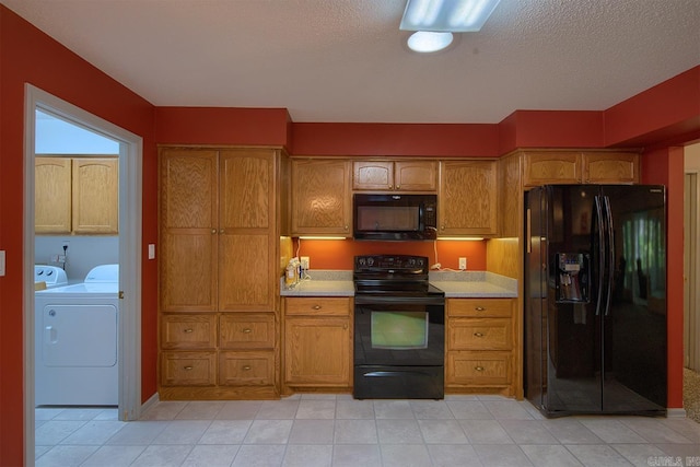 kitchen with separate washer and dryer and black appliances