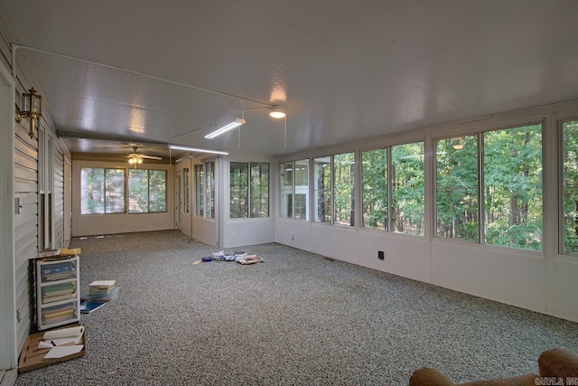 unfurnished sunroom with ceiling fan