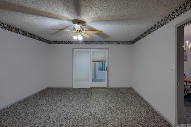 carpeted spare room with ceiling fan and a textured ceiling