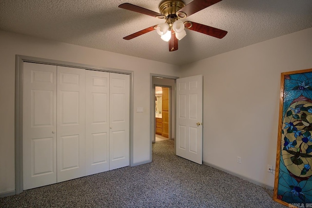 unfurnished bedroom featuring a textured ceiling, carpet floors, a closet, and ceiling fan