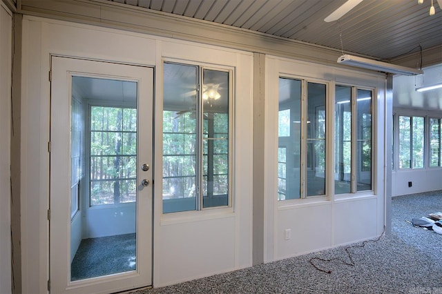 doorway to outside featuring carpet flooring