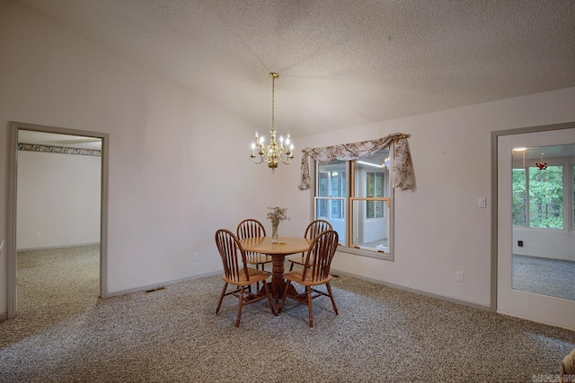 dining space featuring a notable chandelier, plenty of natural light, carpet, and vaulted ceiling