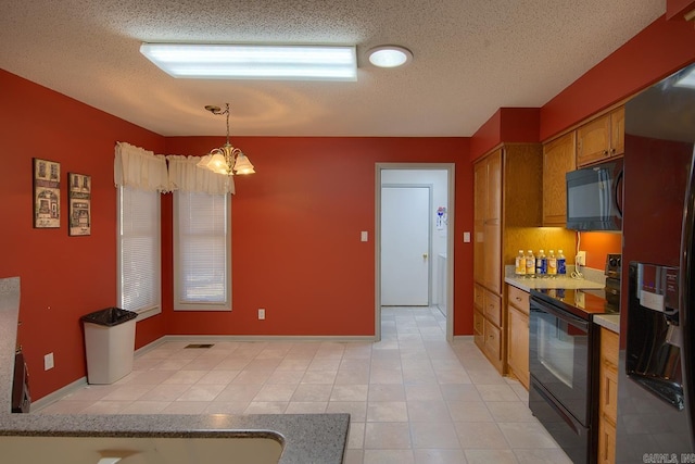 kitchen featuring a textured ceiling, black appliances, pendant lighting, light tile patterned floors, and an inviting chandelier