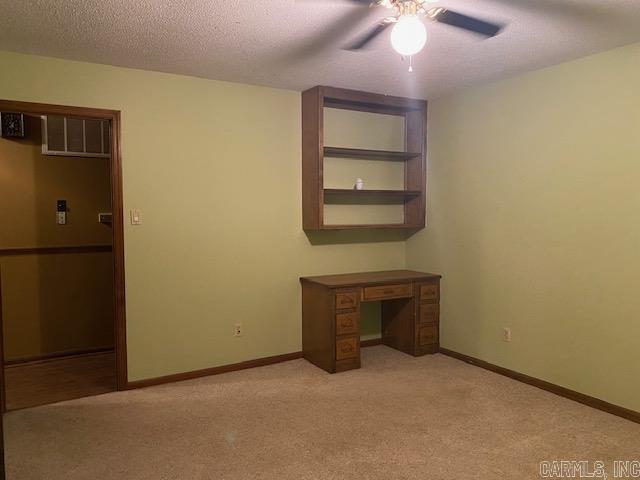 interior space with ceiling fan and a textured ceiling