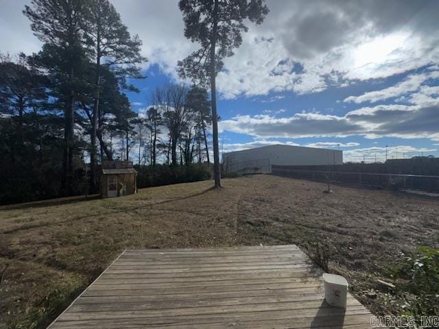 view of yard with a deck and an outdoor structure