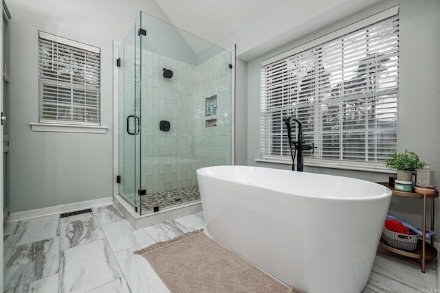 bathroom featuring separate shower and tub and vaulted ceiling