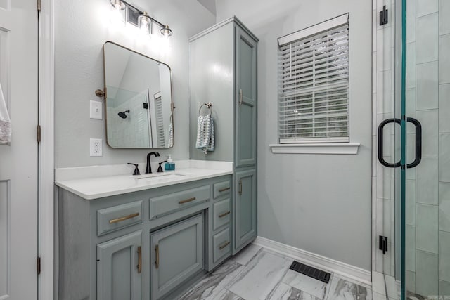 bathroom featuring vanity and a shower with shower door