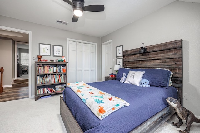 bedroom featuring ceiling fan, a closet, and carpet