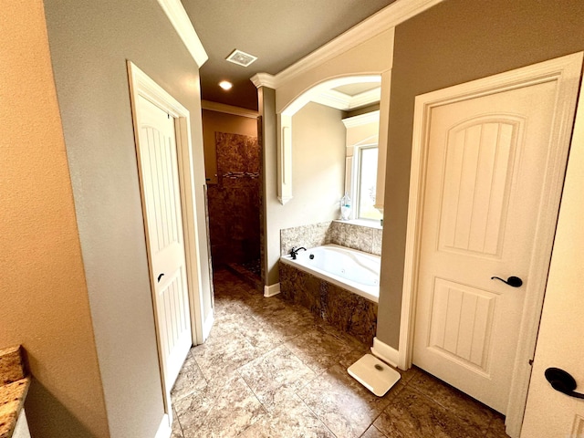 bathroom with tiled bath and crown molding