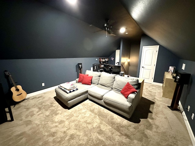 cinema room with light colored carpet, vaulted ceiling, and ceiling fan