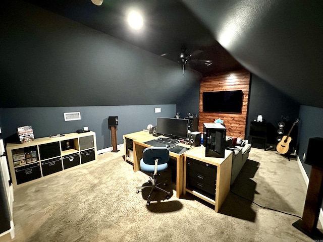 office space with ceiling fan, light carpet, and vaulted ceiling