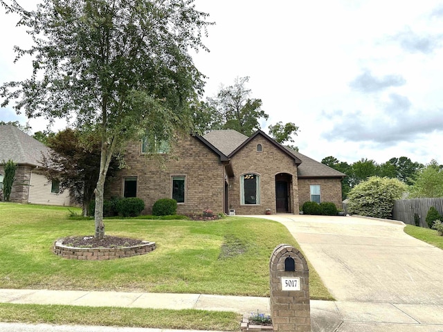 french provincial home featuring a front yard