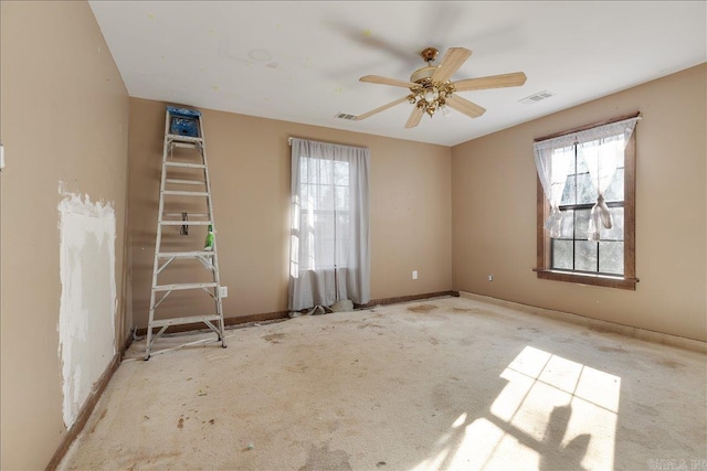 spare room with a wealth of natural light and ceiling fan