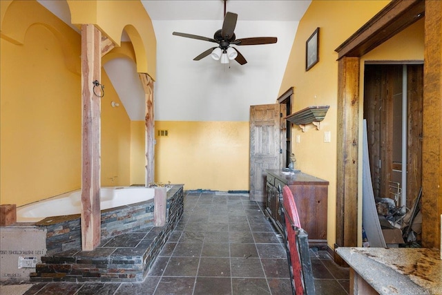 interior space featuring ceiling fan and lofted ceiling