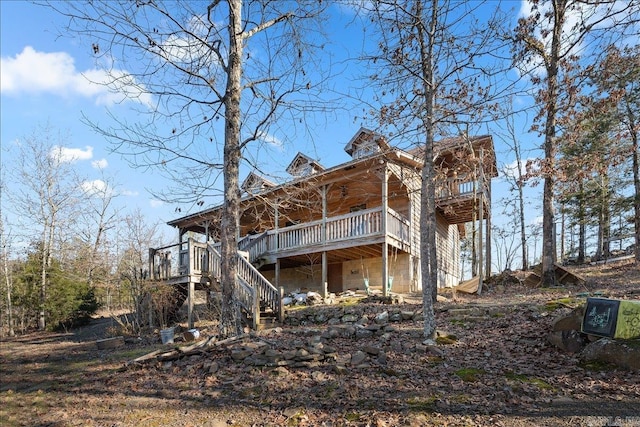 back of house featuring a wooden deck