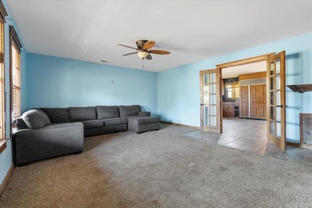 living room with ceiling fan, light carpet, and french doors