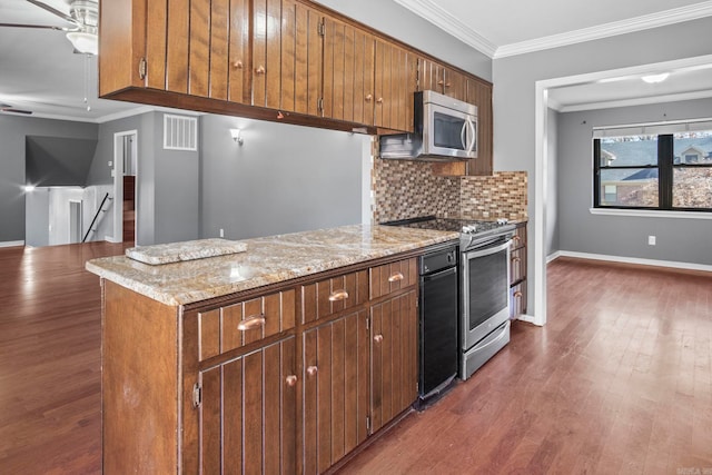 kitchen featuring light stone countertops, crown molding, appliances with stainless steel finishes, and tasteful backsplash