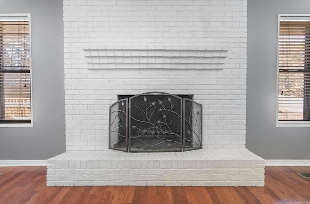 room details featuring hardwood / wood-style floors and a brick fireplace