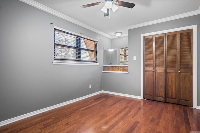 unfurnished bedroom with ceiling fan, ornamental molding, dark wood-type flooring, and a closet