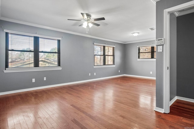 spare room with crown molding, ceiling fan, and wood-type flooring