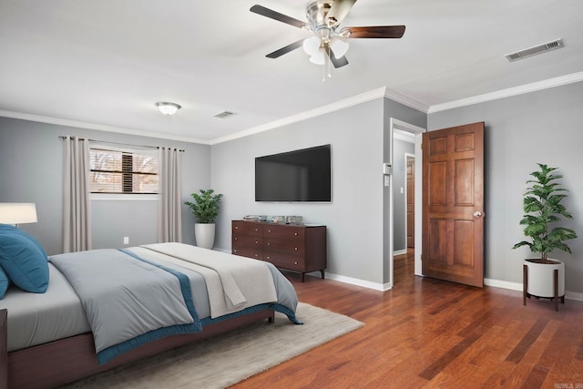 bedroom featuring ceiling fan, dark hardwood / wood-style flooring, and crown molding