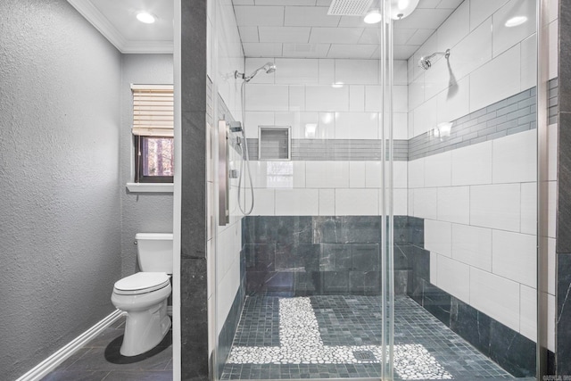 bathroom with toilet, a shower with door, and ornamental molding