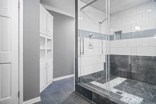 bathroom featuring a shower with shower door and crown molding