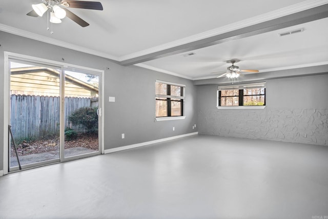 empty room with a healthy amount of sunlight, concrete floors, and crown molding