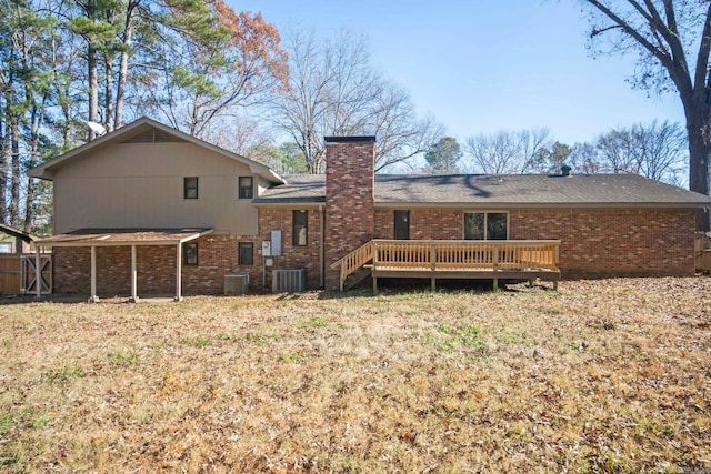 rear view of house with a wooden deck and central AC unit