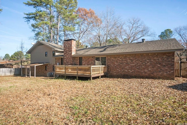 back of property with central AC unit and a wooden deck