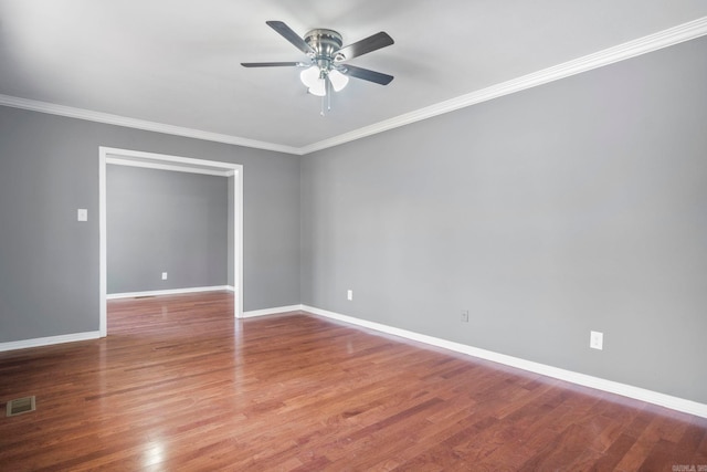 empty room with ceiling fan, hardwood / wood-style floors, and ornamental molding