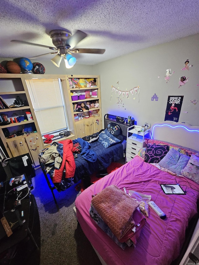 carpeted bedroom featuring ceiling fan and a textured ceiling