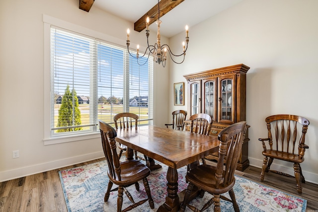 dining space featuring hardwood / wood-style floors, a notable chandelier, and beam ceiling