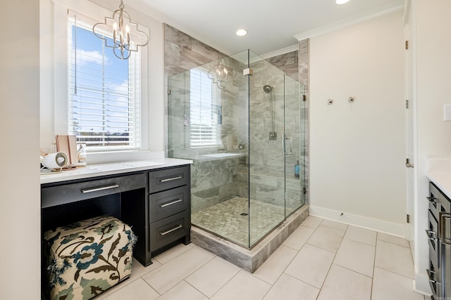 bathroom featuring tile patterned floors, ornamental molding, vanity, a shower with door, and a chandelier