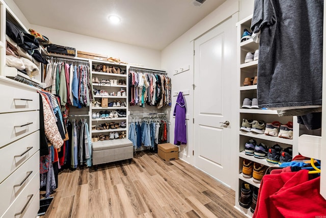 walk in closet featuring light hardwood / wood-style flooring