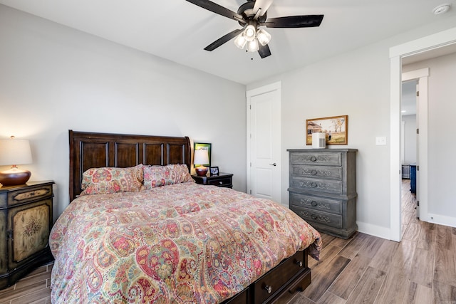 bedroom with ceiling fan and light hardwood / wood-style flooring