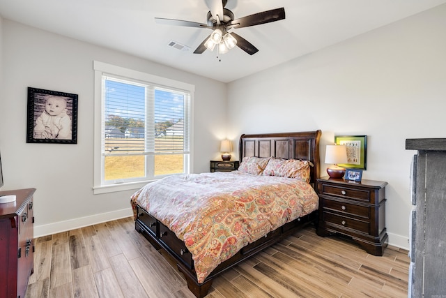 bedroom featuring multiple windows, ceiling fan, and light hardwood / wood-style floors